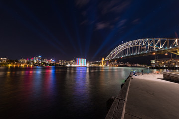 Fototapeta na wymiar Modern futuristic cityscape with bridge and lights at night