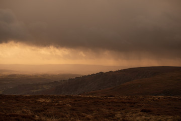Rain sweeping in across hills and moorland