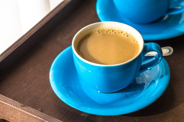 Blurred background view of a mug or coffee cup, a cup of water or a drink on the table, for customer service in a room or restaurant
