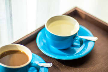 Blurred background view of a mug or coffee cup, a cup of water or a drink on the table, for customer service in a room or restaurant