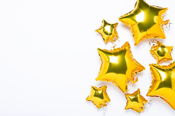 Air golden balloons star shape and candy on a white background. Concept for holiday, party, photo...