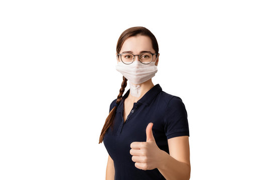 Young Woman With A Medical Mask And Glasses On Her Face Shows Thumb Up As An OK Sign Isolated On A White Background