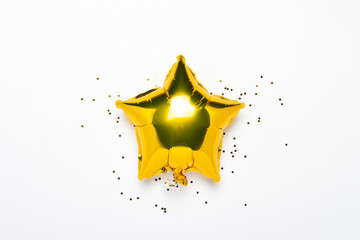 Air golden balloons star shape and candy on a white background. Concept for holiday, party, photo...
