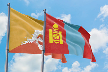 Mongolia and Bhutan flags waving in the wind against white cloudy blue sky together. Diplomacy concept, international relations.