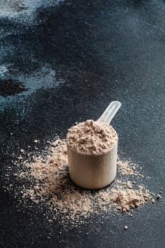 Scoop of Whey Protein in background. Sport nutrition.