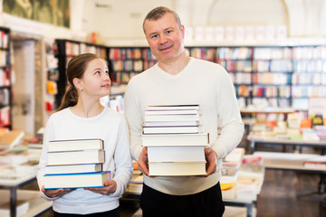 Girl with father holding books