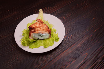 The meat patty with the filling on the redwood table, copy space