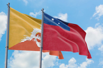 Samoa and Bhutan flags waving in the wind against white cloudy blue sky together. Diplomacy...