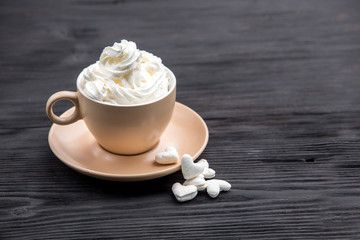 Cup of coffee with decoration -marshmellow, cream, berries