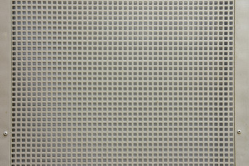 Metal lattice of smooth square holes, gray background closeup