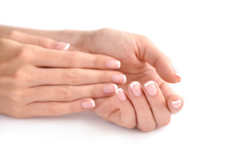 Beautiful woman hands with french manicure on a white background