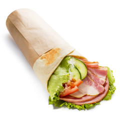 Delicious roll with ham, salami and fresh vegetables, isolated on white background