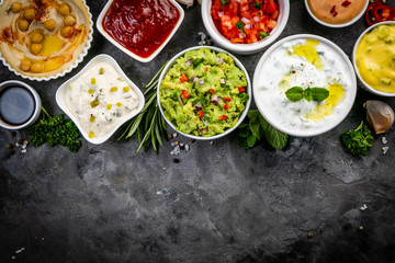 Selection of sauces in white bowls on white bowls, top view