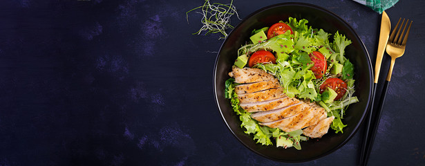 Chicken grilled fillet with salad fresh tomatoes and avocado. Healthy food, ketogenic diet, diet lunch concept. Keto/Paleo diet menu. Top view, banner