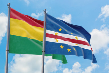 Cape Verde and Bolivia flags waving in the wind against white cloudy blue sky together. Diplomacy concept, international relations.