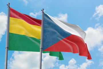 Czech Republic and Bolivia flags waving in the wind against white cloudy blue sky together. Diplomacy concept, international relations.