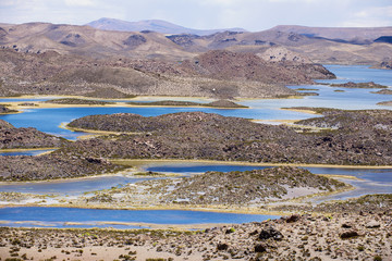 Volcanic landscape with lagoons at 3.200 meters above sea level in Lauca National park, Chile.