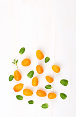 Organic kumquats on white background.