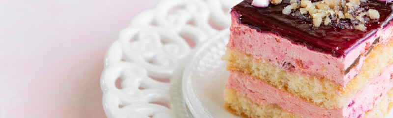 Yummy slice of strawberry cake on pink background, creamy dessert, holiday themes