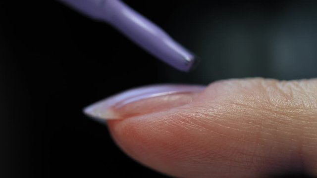 Manicure nail paint. Master applies gel polish on nails  in manicure salon. Nail polish.