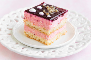Yummy slice of strawberry cake on pink background, creamy dessert, holiday themes