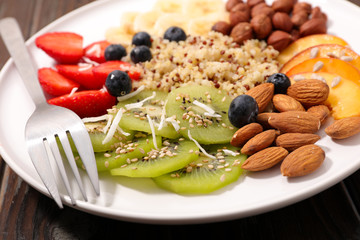 plate with quinoa, fruits and nuts- healthy eating