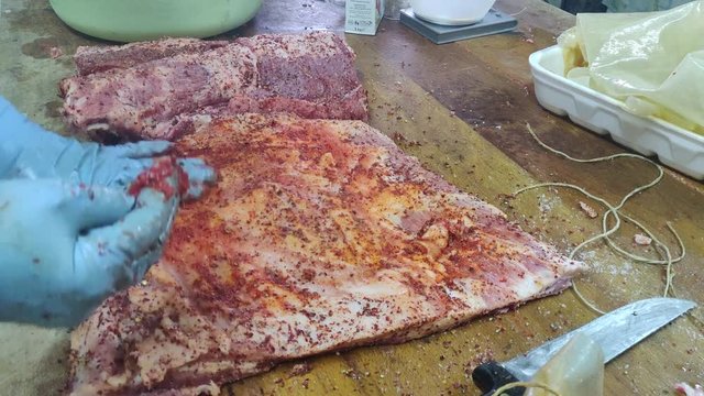 homemade bacon production. Meat flavored with aromas. Capocollo flavored with hot pepper, black pepper and papikra. Video high quality 4k hd.