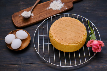 Flour on a wooden table for making sponge cake, black background
