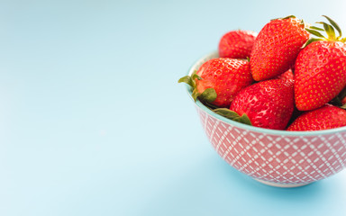 strawberries in a colorful bowl on a colorful background