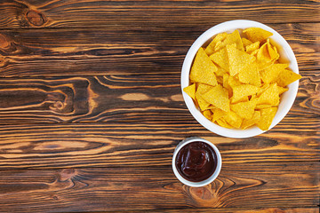 Mexican nachos with cheese. Corn chips with guacamole, salsa and tomato ketchup.