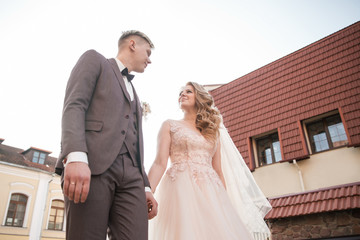 Fototapeta premium bride and groom walking down the street of the old town.