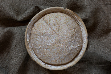 Proofing dough in a special basket. Raise the dough before baking. Yeast-free dough. The fermentation process of the dough.