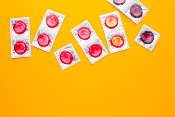 color condom in isolated on a yellow background
