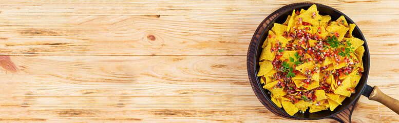 Mexican nachos with cheese. Corn chips with guacamole, salsa and tomato ketchup.