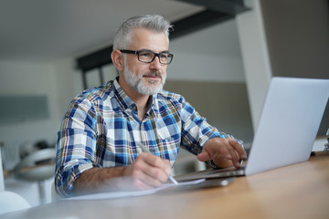 Man working from home on laptop computer