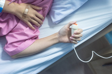 Patient hands press nurse call button on the bed in hospital, Hand of patient press emergency button