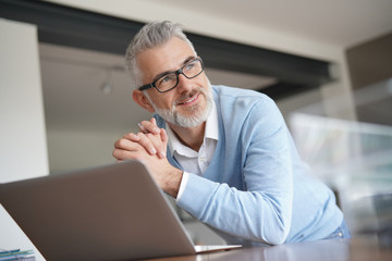 Man in office working on laptop computer