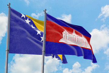 Cambodia and Bosnia Herzegovina flags waving in the wind against white cloudy blue sky together. Diplomacy concept, international relations.