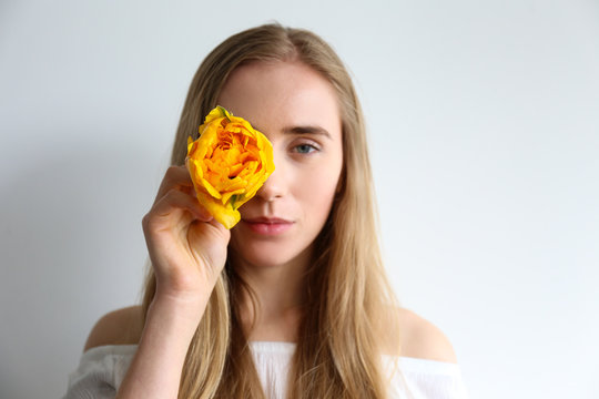 Conceptual image of a woman holding spring flowers as present for international women's day. Close up, copy space, background.