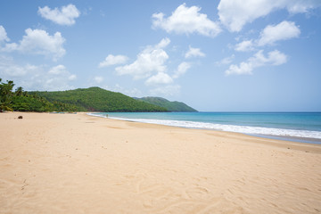 A view of tropical beach with sea, sand and blue sky,during the day on a public beach in Rincon Beach,Samana peninsula, Dominican Republic