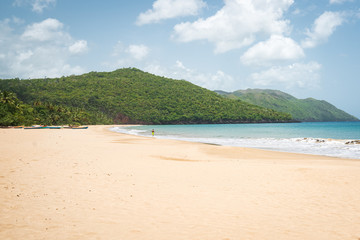 Fototapeta na wymiar A view of tropical beach with sea, sand and blue sky,during the day on a public beach in Rincon Beach,Samana peninsula, Dominican Republic