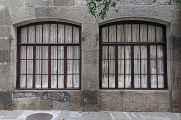 old wooden window in stone wall