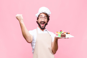 young crazy baker man confectionery concept against pink wall