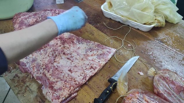 homemade bacon production. Meat flavored with aromas. Capocollo flavored with hot pepper, black pepper and papikra. Video high quality 4k hd.