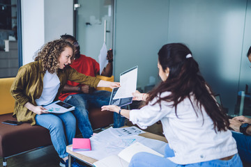 Surprised female looking at chart working with partners