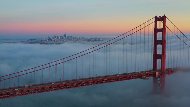 Aerial view of Golden Gate Bridge in San Francisco during beautiful sunset with mist. USA, California