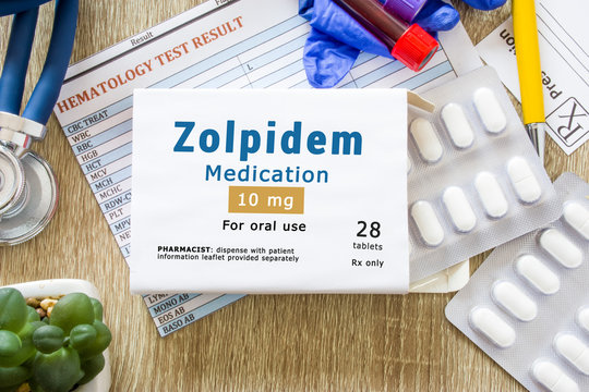Zolpidem medication as international nonproprietary or generic name concept photo. Packaging of drugs labeled "Zolpidem medication" is on doctor table with stethoscope