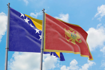 Montenegro and Bosnia Herzegovina flags waving in the wind against white cloudy blue sky together. Diplomacy concept, international relations.