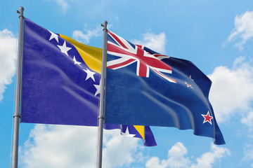 New Zealand and Bosnia Herzegovina flags waving in the wind against white cloudy blue sky together. Diplomacy concept, international relations.