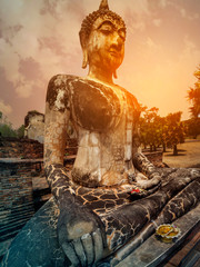 Fototapeta na wymiar Buddha statue in the sunlight at Sukhothai Historical Park